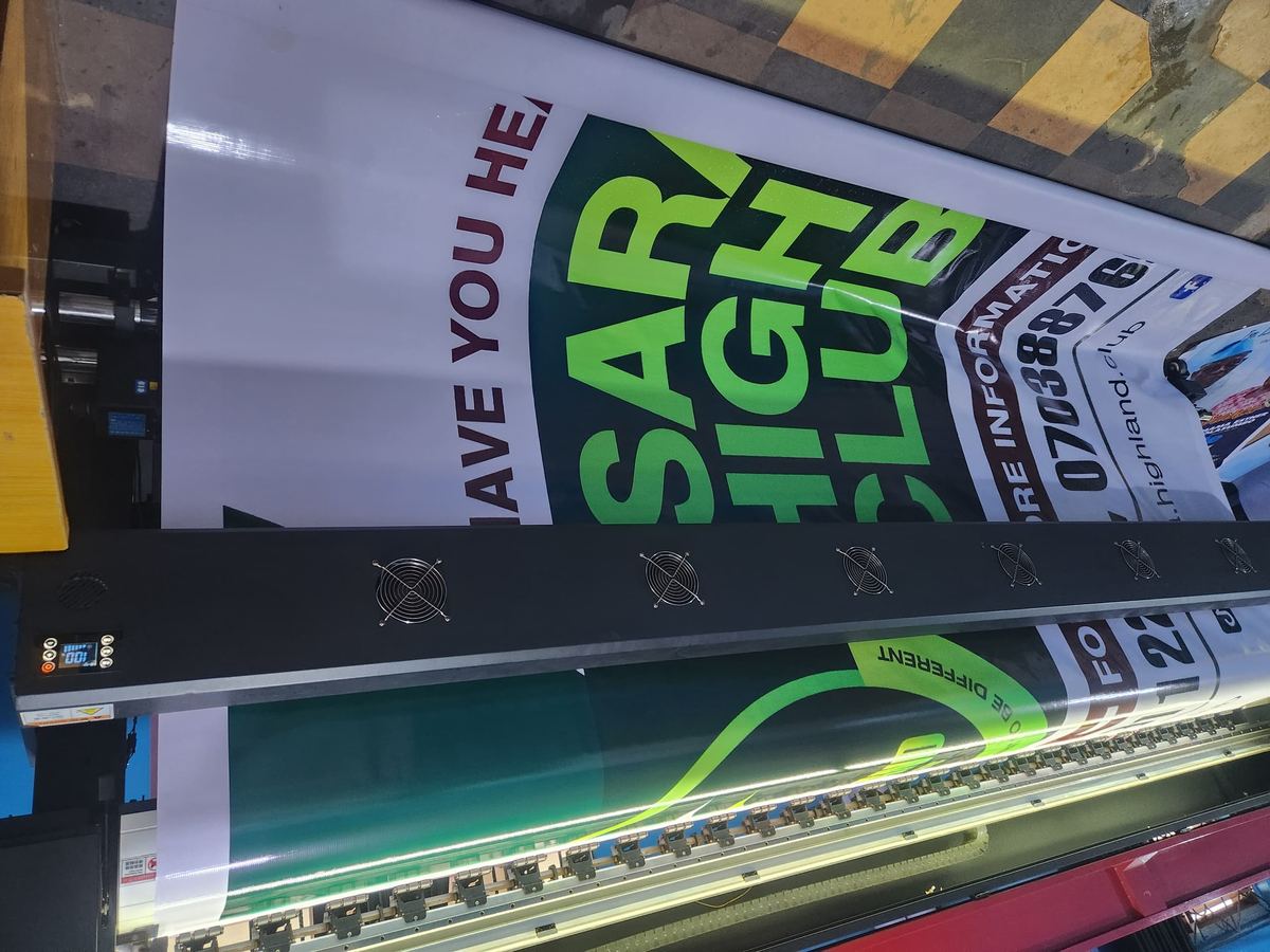 A club banner being printed on the wide-format machine