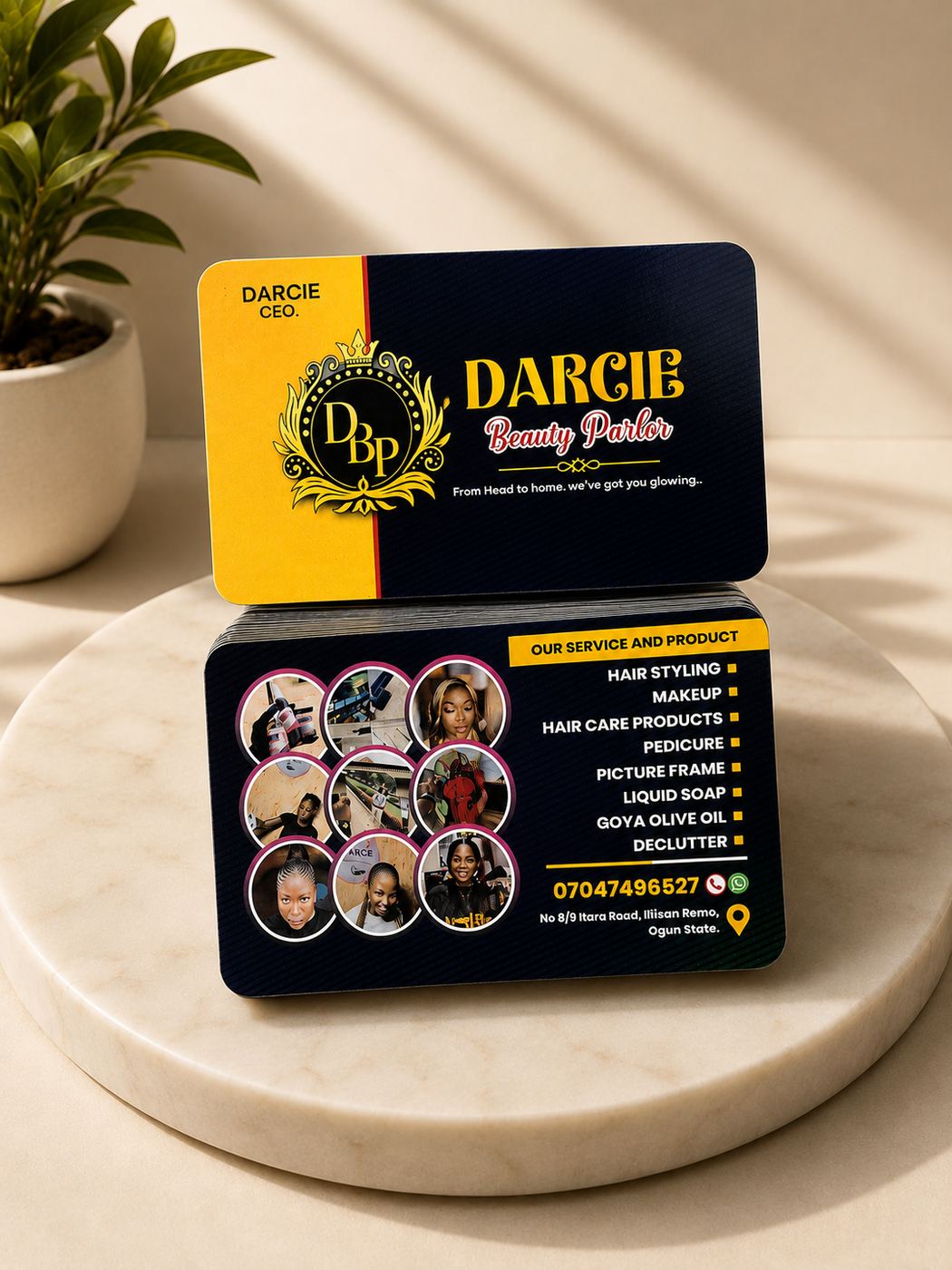 A banded stack of gloss-laminated business cards for Darcie Beauty Parlor, showing both faces