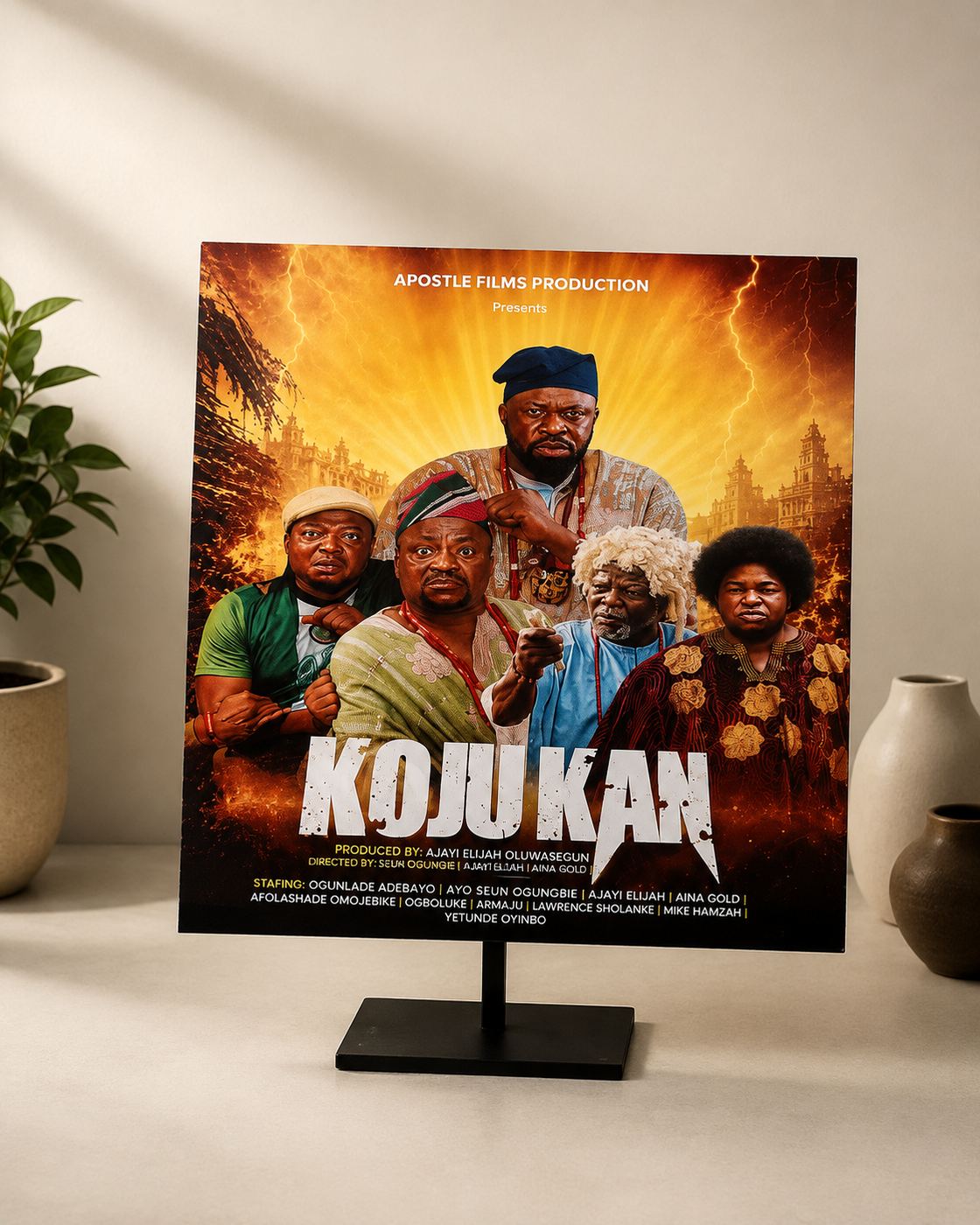 Mounted film poster for Koju Kan, an Apostle Films production, on a display stand