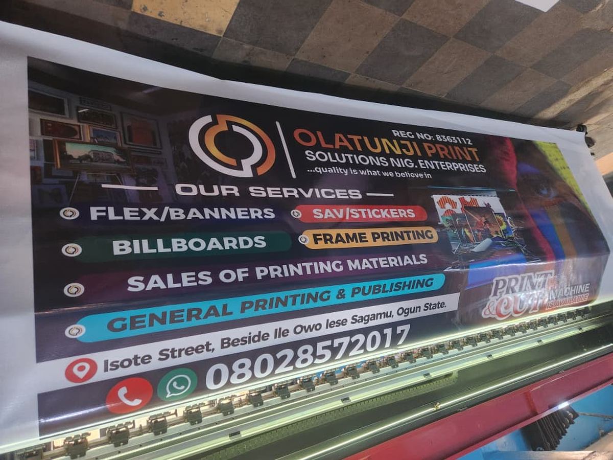 Wide flex banner listing Olatunji Print Solutions services, fresh off the press