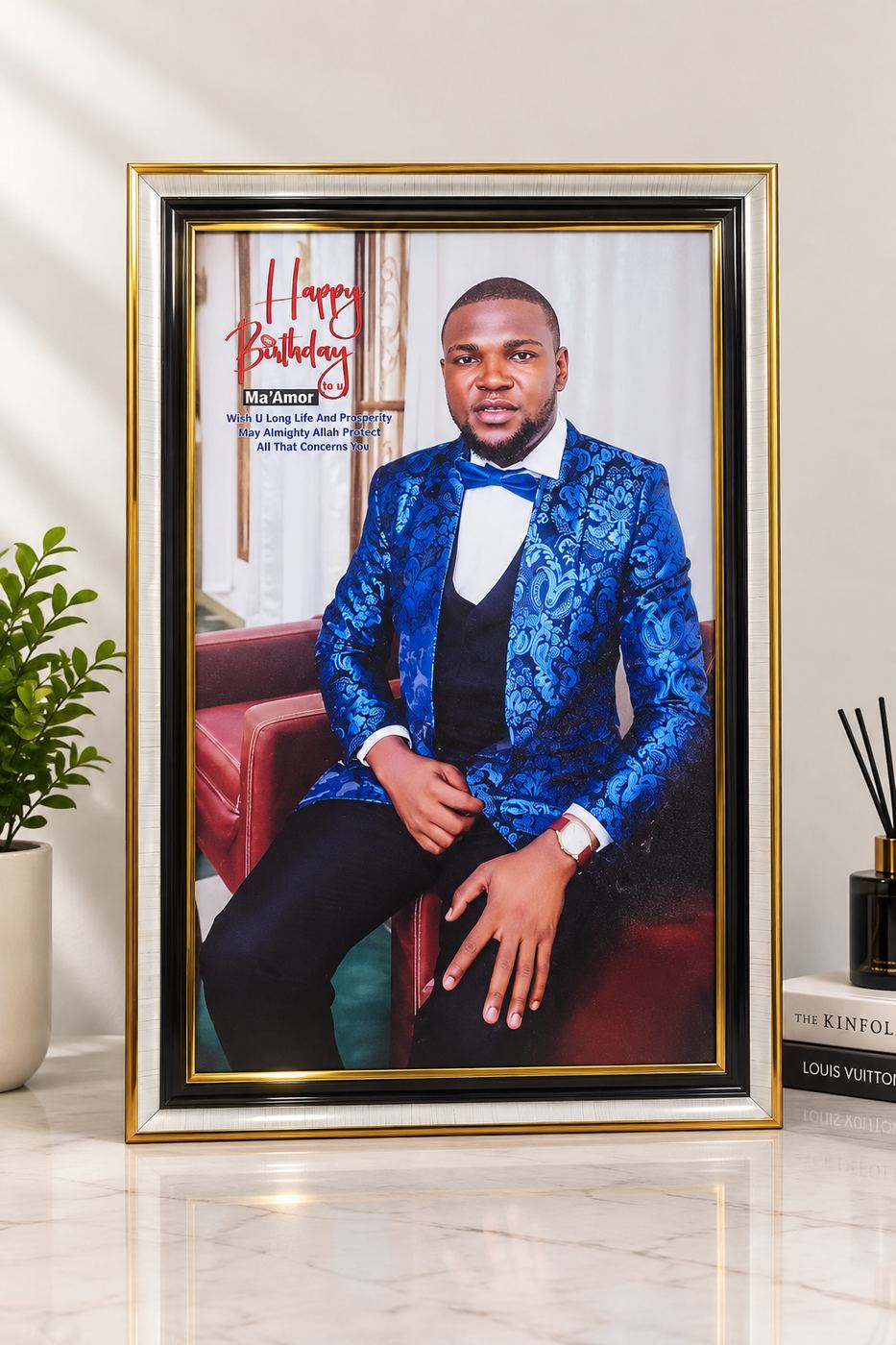 A framed birthday portrait print in a gold and black frame