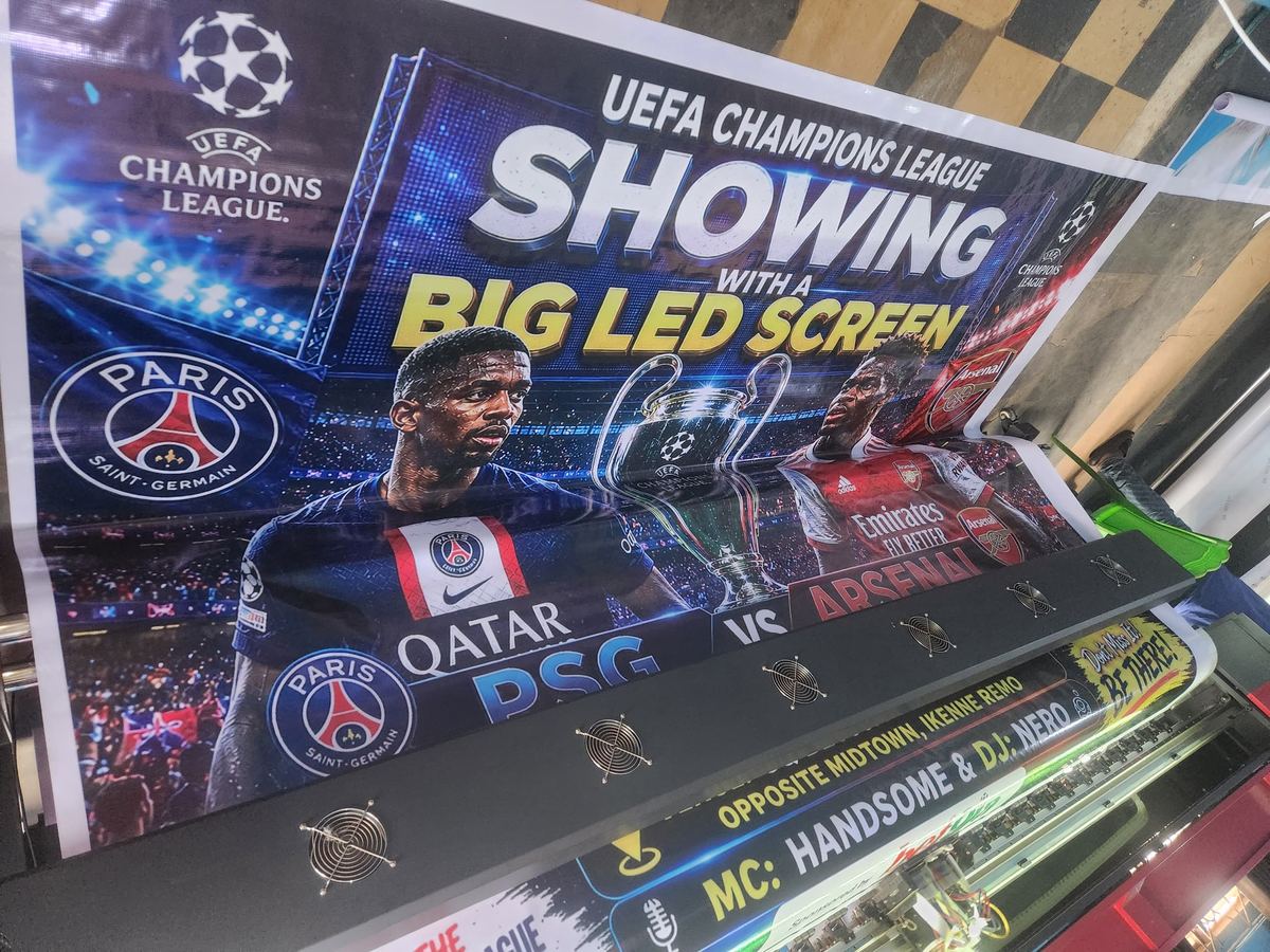 A Champions League viewing banner coming off the wide-format press