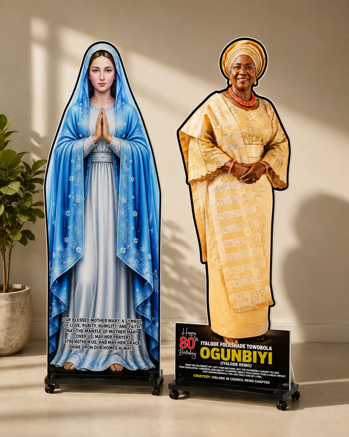 Two life-size contour-cut standees on wheeled bases, a devotional figure and an 80th birthday tribute